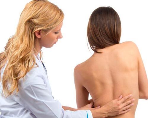 the doctor examines the back for low back pain